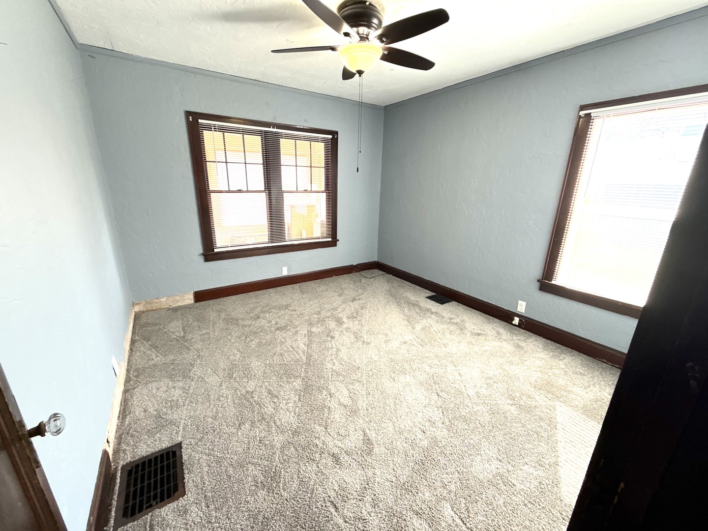 302 West Division Street Amboy, IL 61310 - Photo 17 of 23 an empty room with windows and ceiling fan