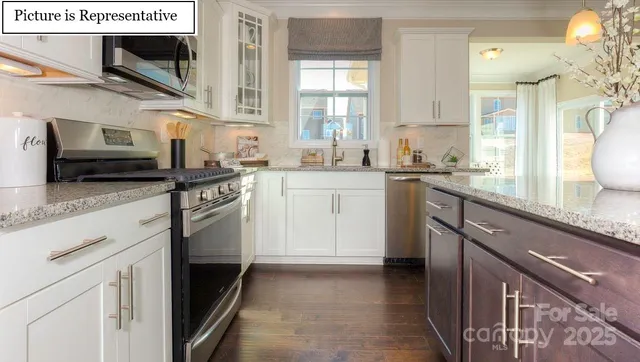 a kitchen with stainless steel appliances granite countertop a sink and a stove
