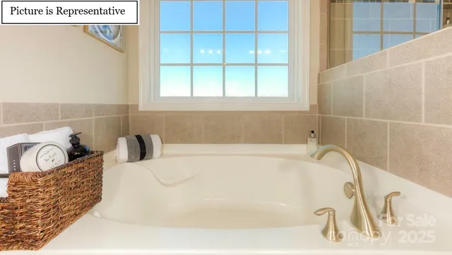 a bathroom with a tub sink and vanity