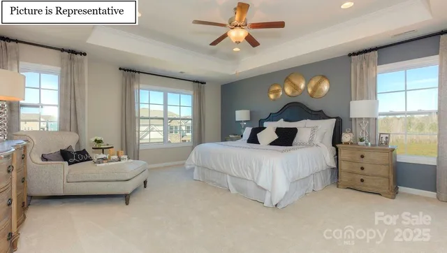 a spacious bedroom with a bed and a large window