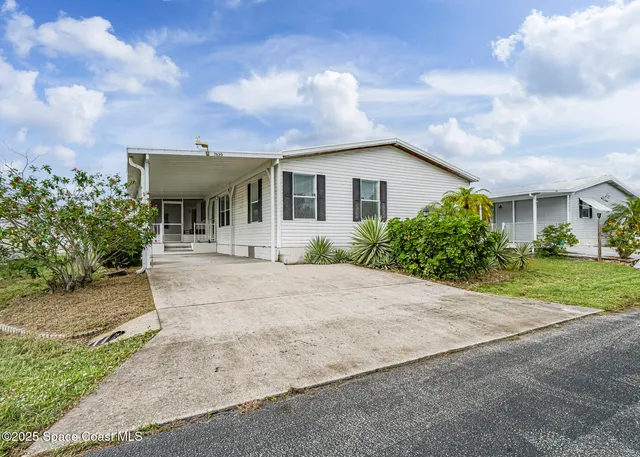 a front view of a house with a yard and a garage