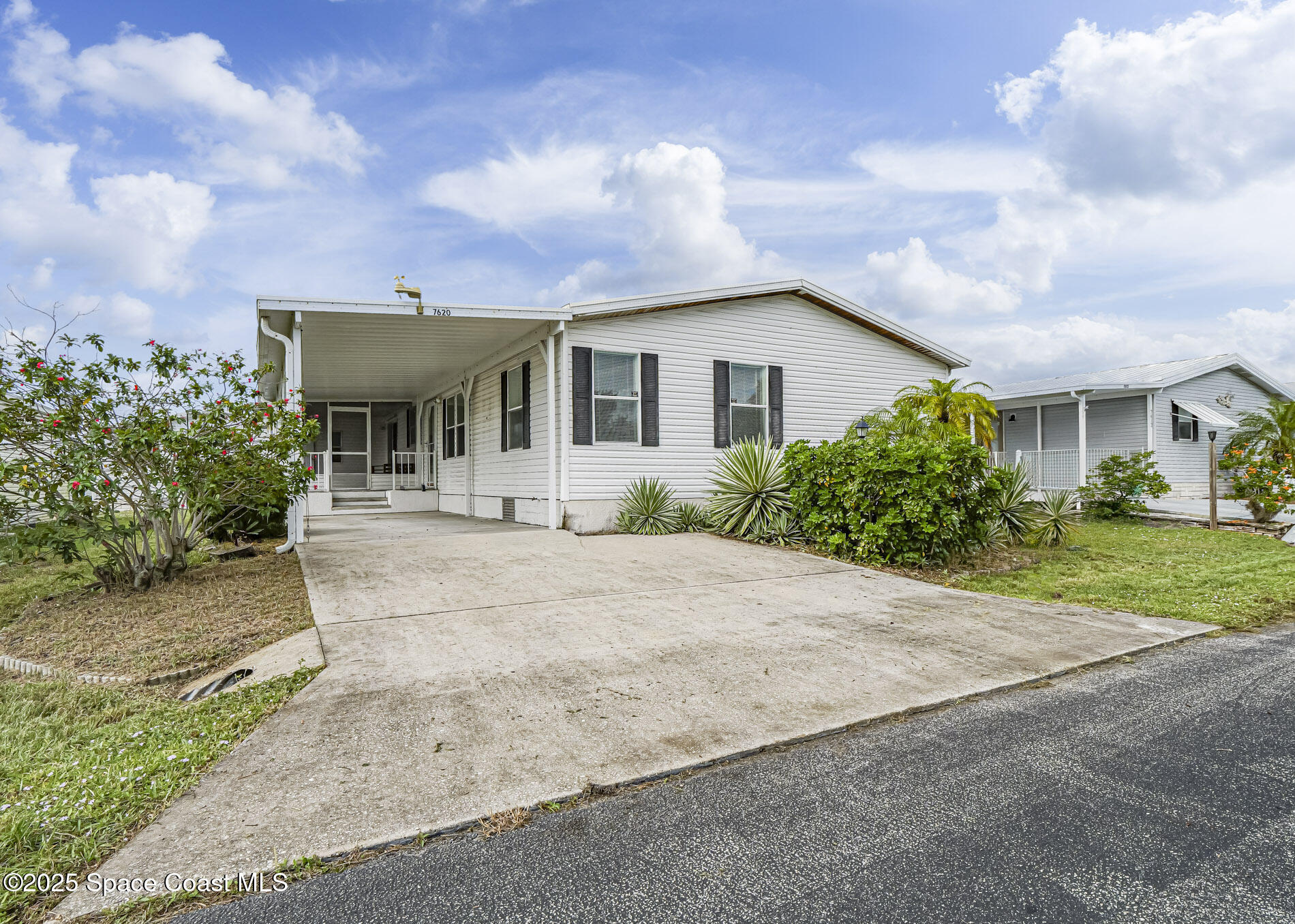 a front view of a house with a yard and a garage