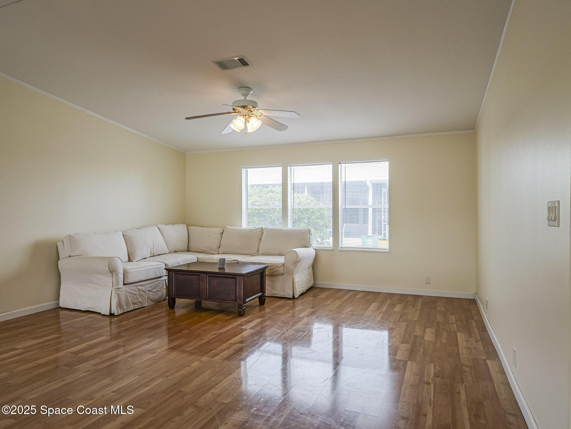 7620 Boxelder Road Micco, FL 32976 - Photo 11 of 47 a living room with furniture and a large window