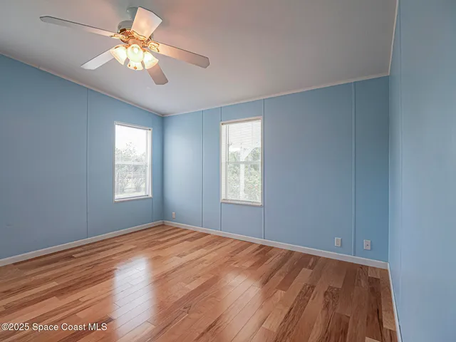 a view of room with window and ceiling fan