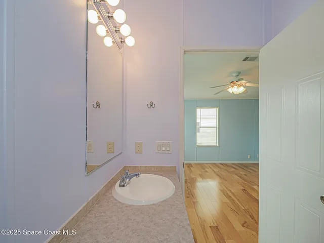 a bathroom with a sink toilet and a mirror