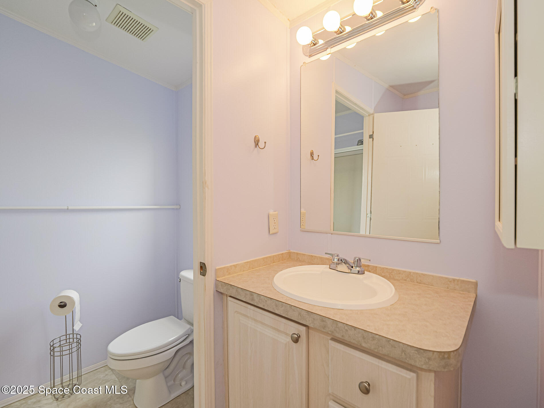 7620 Boxelder Road Micco, FL 32976 - Photo 22 of 47 a bathroom with a sink toilet and a mirror