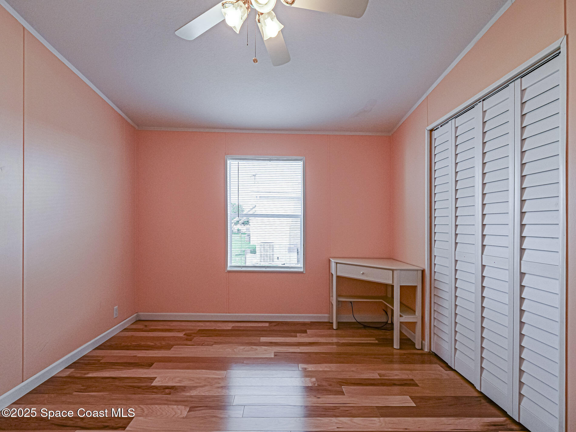7620 Boxelder Road Micco, FL 32976 - Photo 25 of 47 a view of empty room with wooden floor and fan