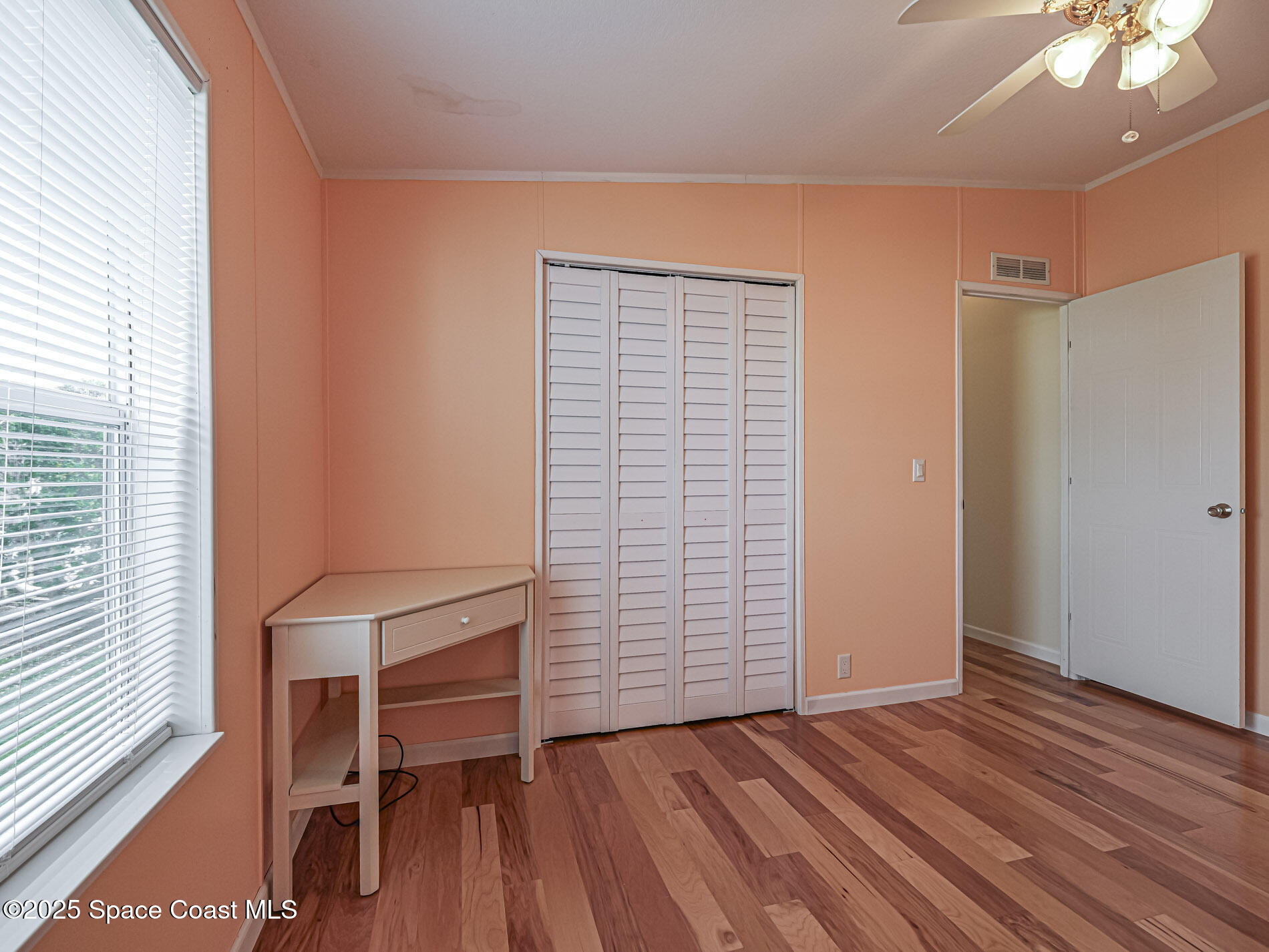 7620 Boxelder Road Micco, FL 32976 - Photo 26 of 47 a view of room with wooden floor and fan