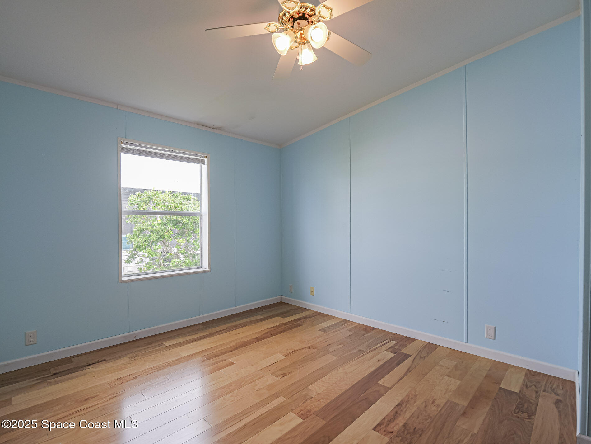7620 Boxelder Road Micco, FL 32976 - Photo 29 of 47 a view of empty room with wooden floor and fan