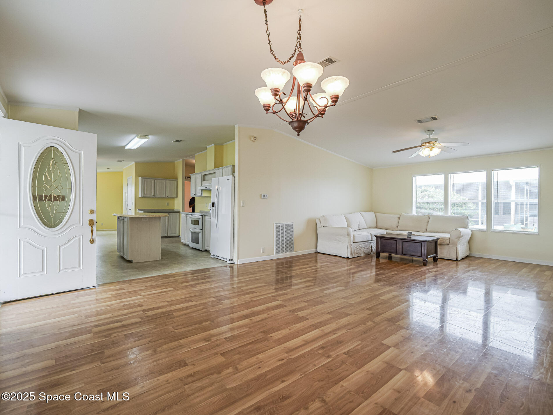 7620 Boxelder Road Micco, FL 32976 - Photo 32 of 47 a living room with fireplace furniture and a large window