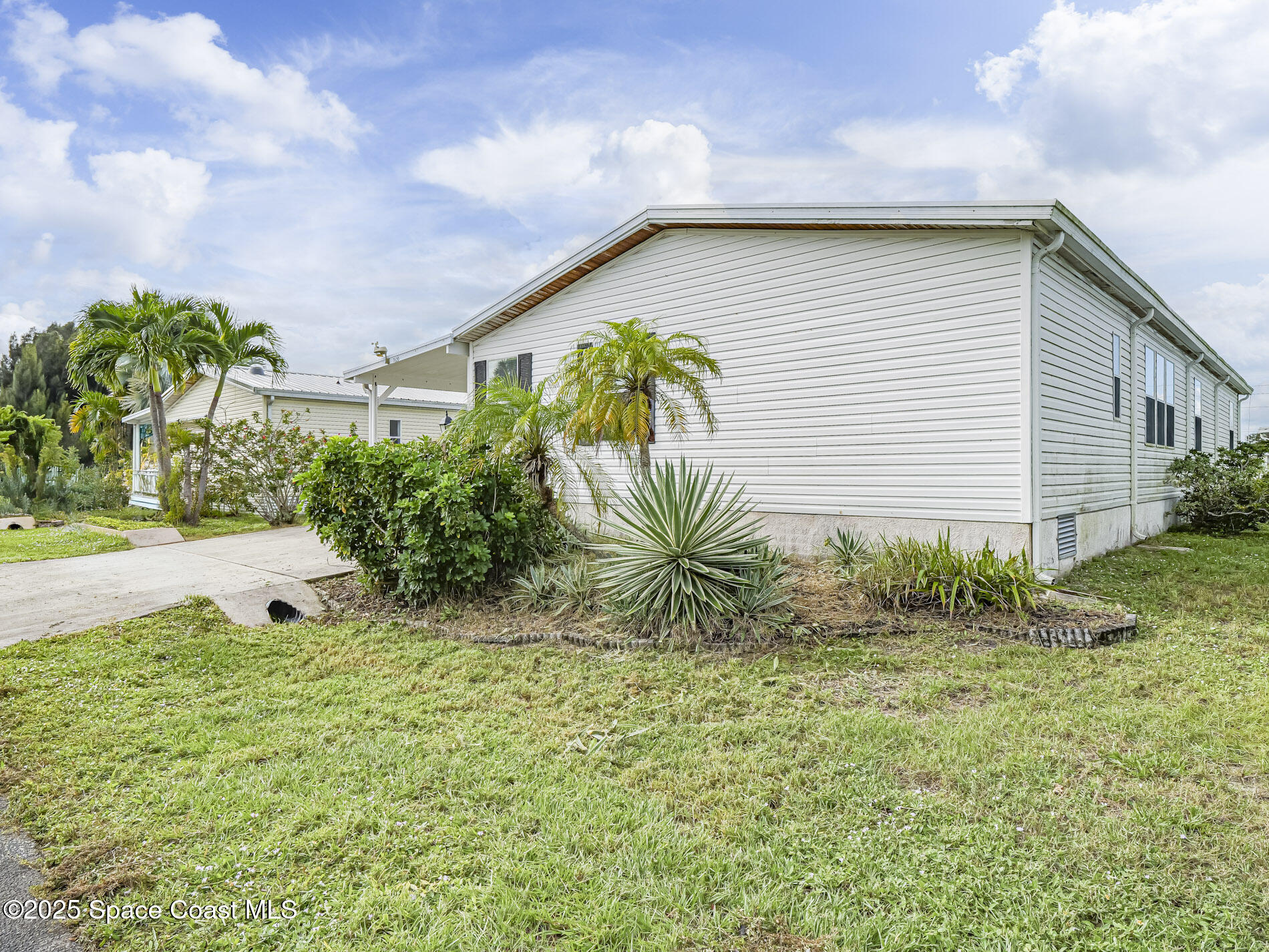 7620 Boxelder Road Micco, FL 32976 - Photo 38 of 47 a yellow house with lots of trees