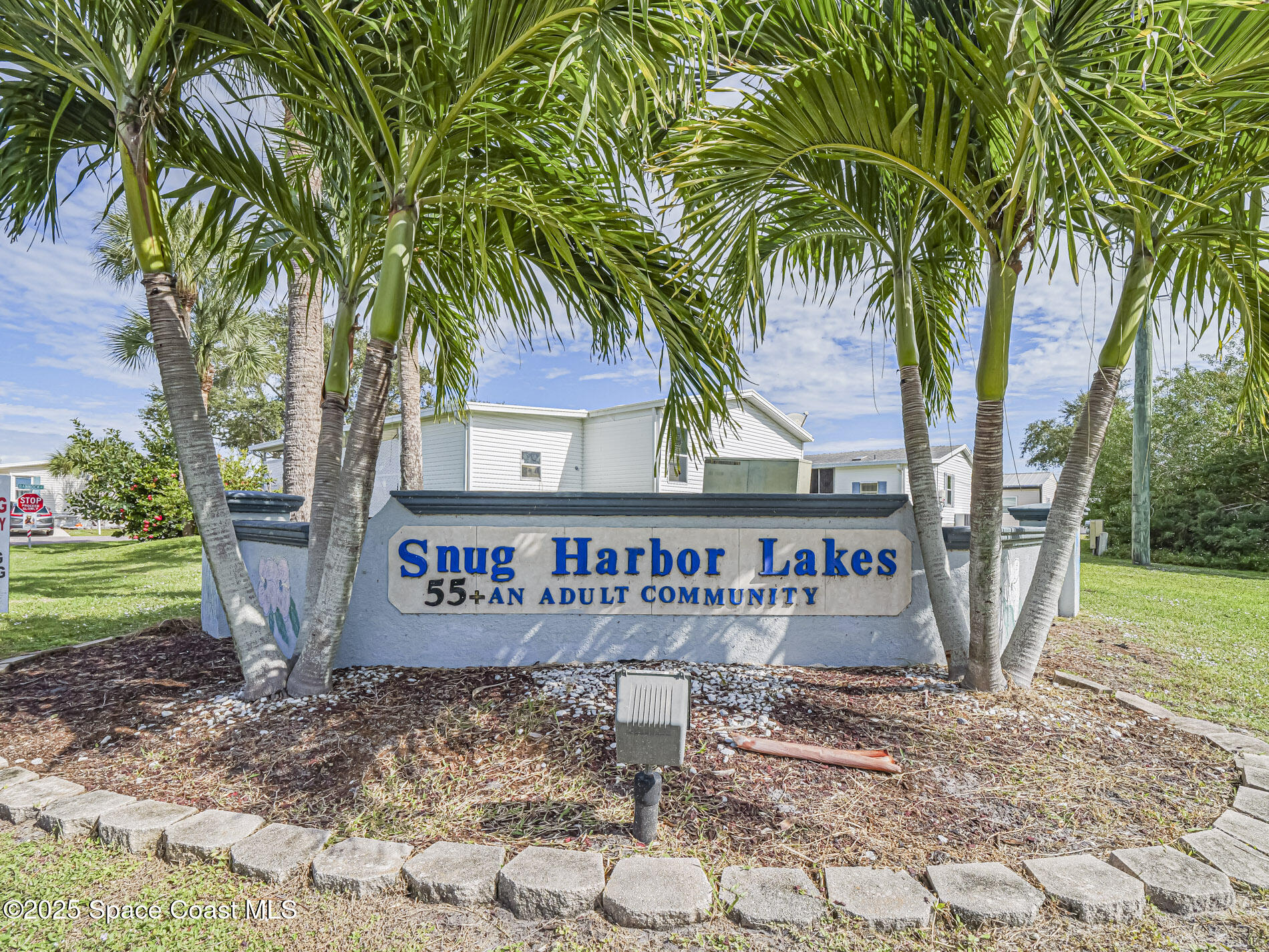 7620 Boxelder Road Micco, FL 32976 - Photo 6 of 47 a sign that is sitting in front of a house with a yard