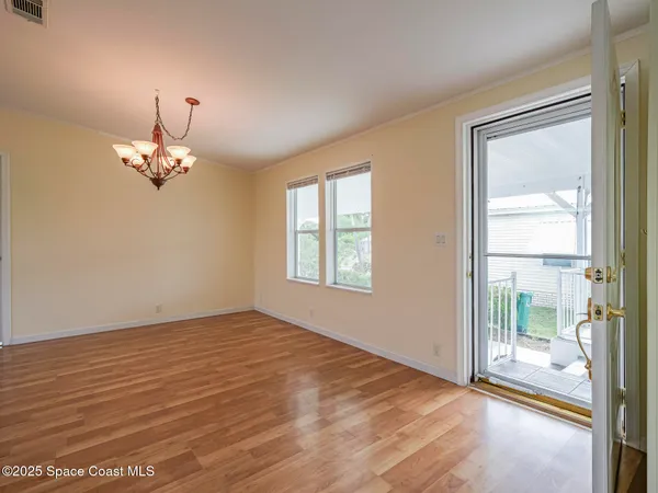 a kitchen with a white cabinets stove sink and dishwasher with wooden floor