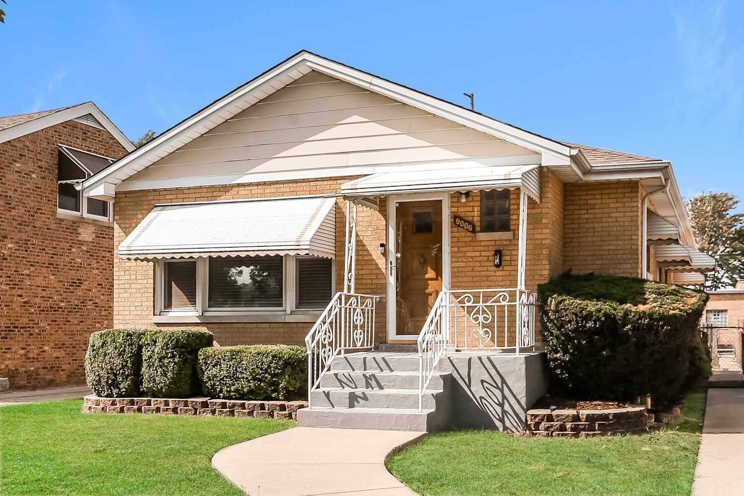a front view of a house with garden