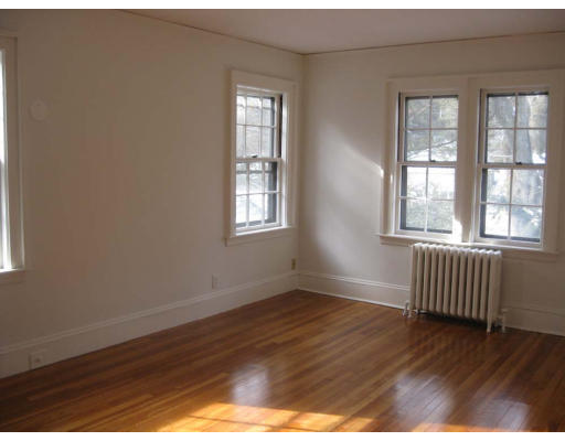 27 Algonquin Road Newton, MA 02467 - Photo 14 of 20 an empty room with wooden floor and windows