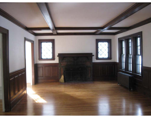 27 Algonquin Road Newton, MA 02467 - Photo 5 of 20 a view of an empty room with a fireplace and a window