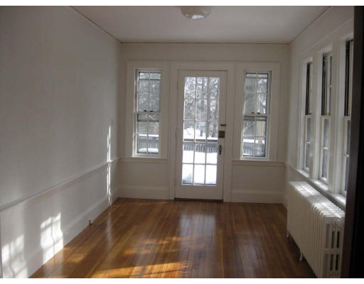 27 Algonquin Road Newton, MA 02467 - Photo 6 of 20 a view of an empty room with wooden floor and a window