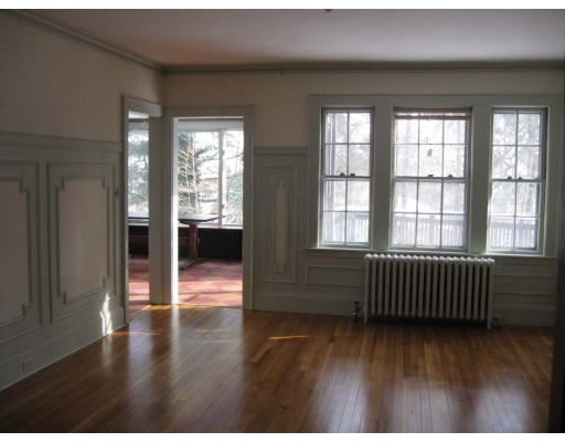 27 Algonquin Road Newton, MA 02467 - Photo 7 of 20 a view of an empty room with wooden floor and windows