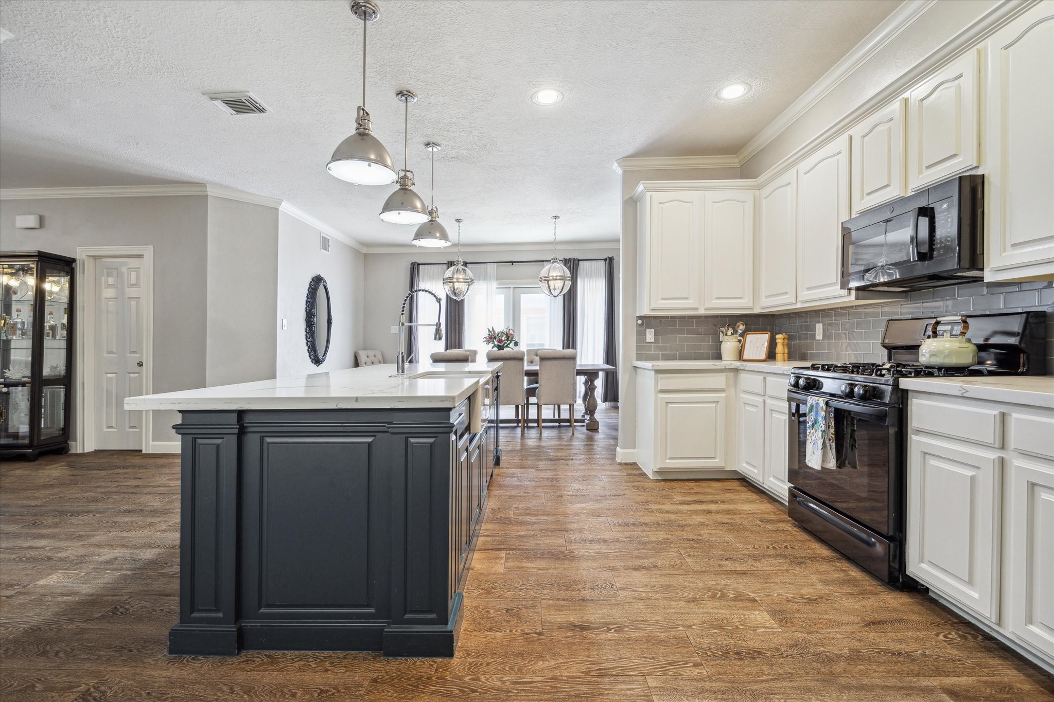 1310 Cohn Street Houston, TX 77007 - Photo 10 of 25 The spacious kitchen offers plenty of room to move, cook, and gather, with an open layout that invites connection and conversation.