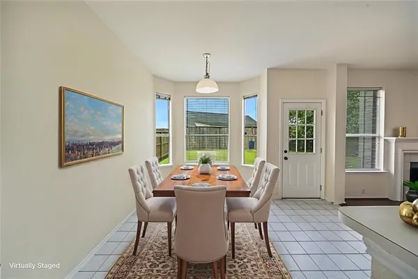 a dining room with furniture a chandelier and wooden floor
