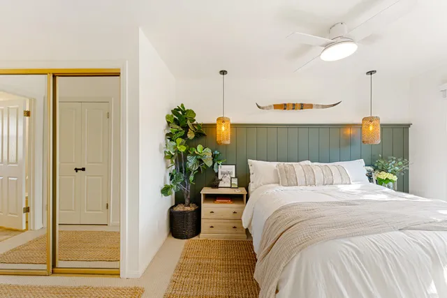 a bedroom with a bed and a large window