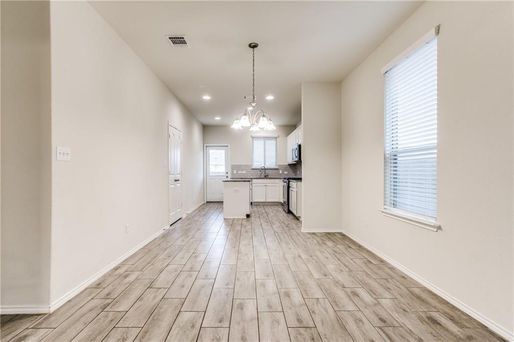 1413 Cliffbrake Way Georgetown, TX 78626 - Photo 9 of 30 a view of a room with wooden floor a ceiling fan and windows