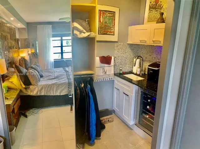 a kitchen with a sink appliances and cabinets