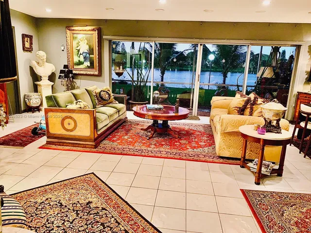 a living room with patio furniture and a table