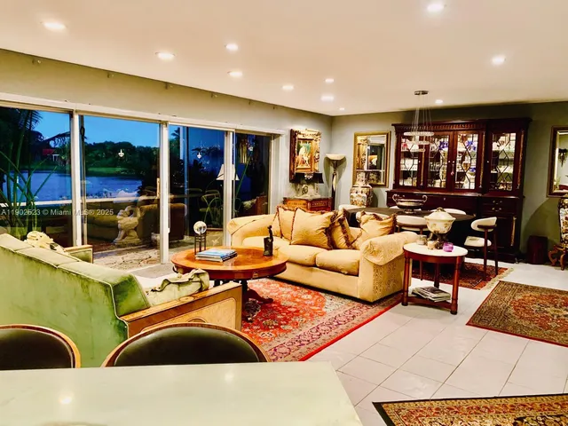 a living room with furniture ceiling fan and floor to ceiling window