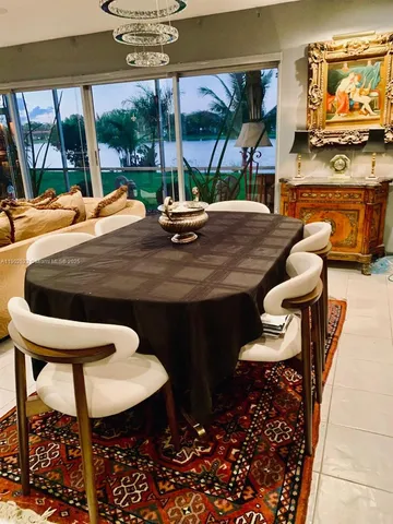 a view of a dining room with furniture large windows and wooden floor