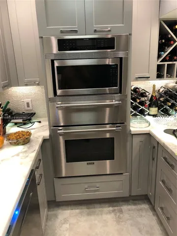 a kitchen with granite countertop a stove and a sink