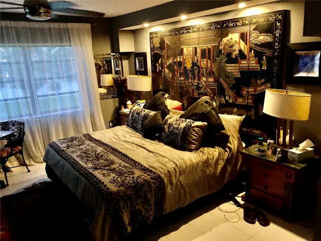 a bedroom with bed and a window