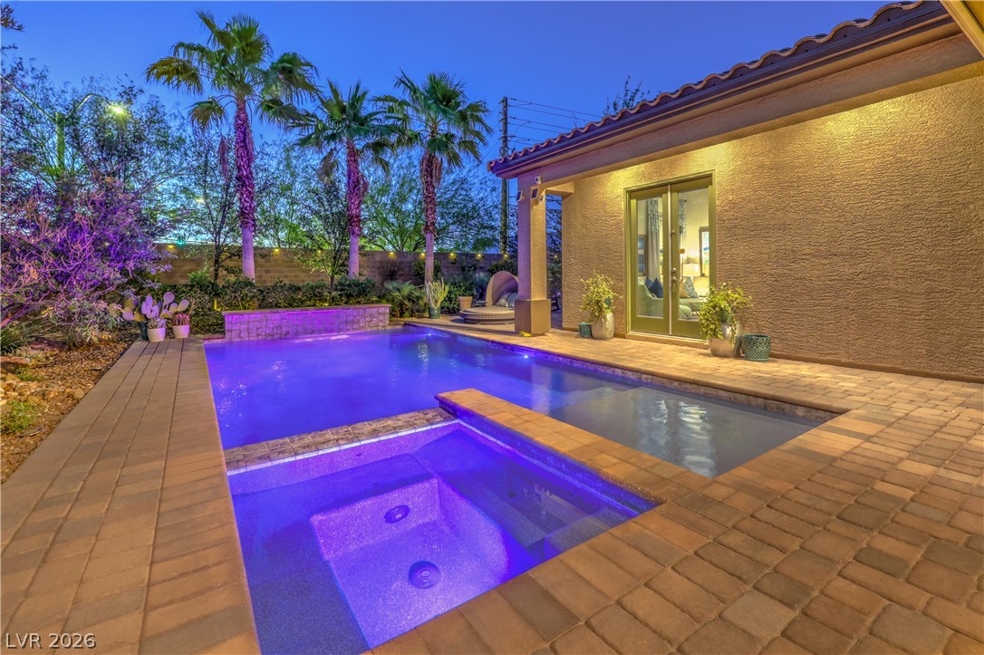 7119 Arabian Ridge Street Las Vegas, NV 89131 - Photo 48 of 73 A private backyard oasis features a shimmering pool and spa, ideal for relaxation and entertaining.