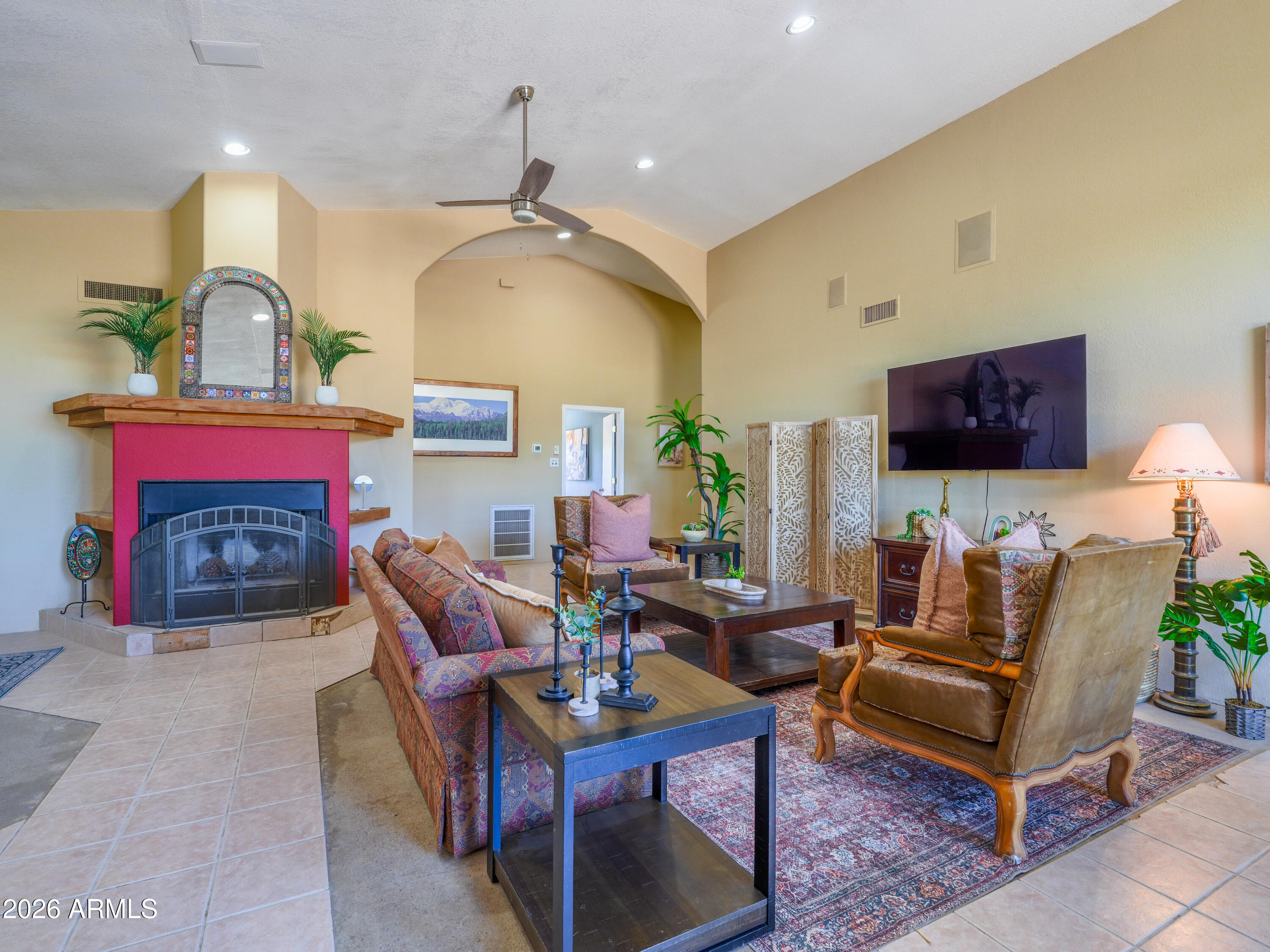 1224 North Acacia Road Apache Junction, AZ 85119 - Photo 6 of 48 a living room with furniture a flat screen tv and a fireplace