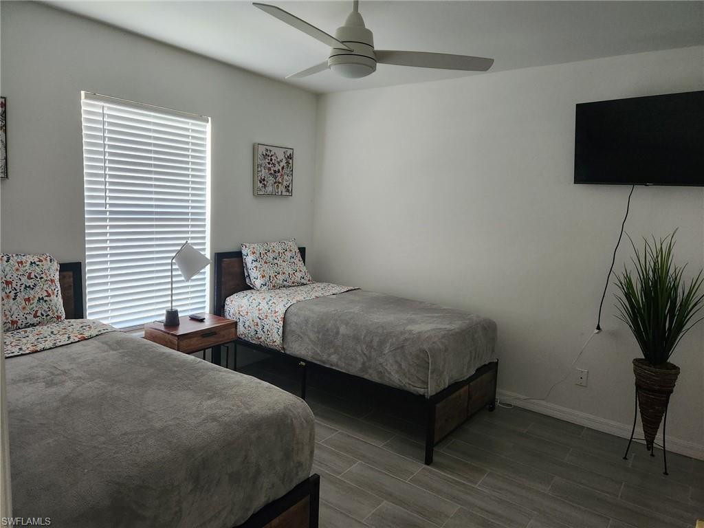 650 103rd Avenue North Naples, FL 34108 - Photo 11 of 13 a bedroom with two beds and a flat screen tv