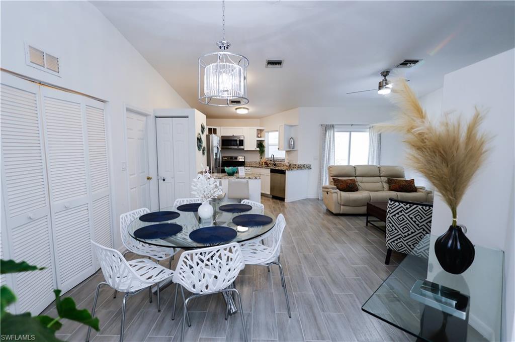650 103rd Avenue North Naples, FL 34108 - Photo 2 of 13 a living room with furniture and a chandelier