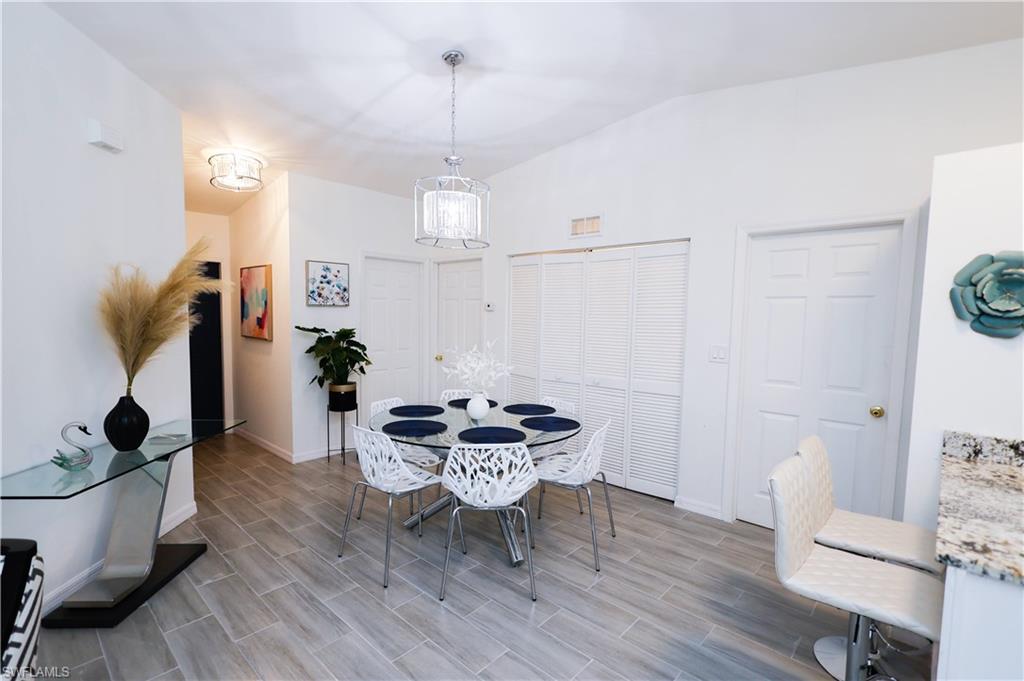 650 103rd Avenue North Naples, FL 34108 - Photo 5 of 13 a dining room with furniture and wooden floor