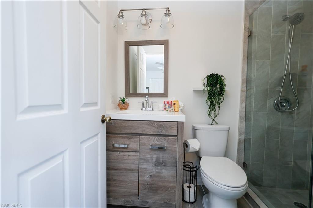 650 103rd Avenue North Naples, FL 34108 - Photo 8 of 13 a bathroom with a sink toilet and shower