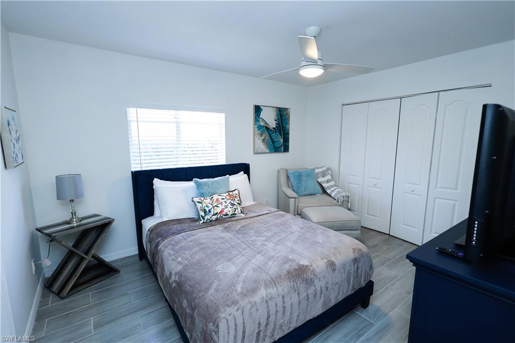 650 103rd Avenue North Naples, FL 34108 - Photo 10 of 13 a bedroom with a bed tv and a window