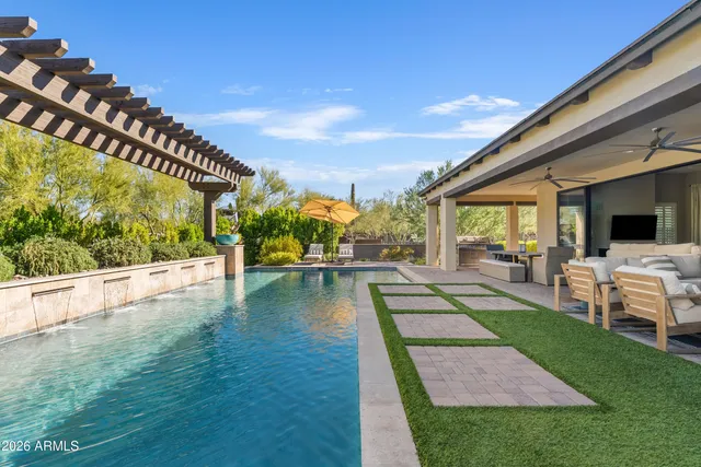 a view of swimming pool with seating area and furniture in front of it