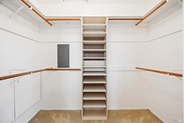 a view of walk in closet with empty racks