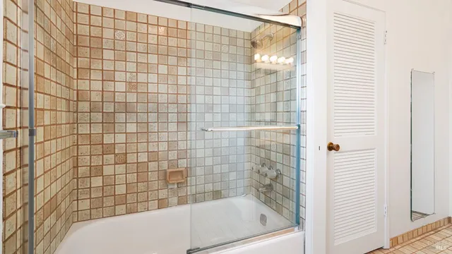 a bathroom with a bathtub and shower