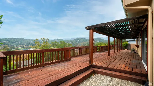 a view of balcony with wooden floor and outdoor seating