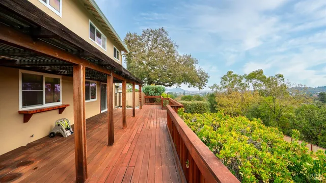 a view of balcony with wooden floor and fence