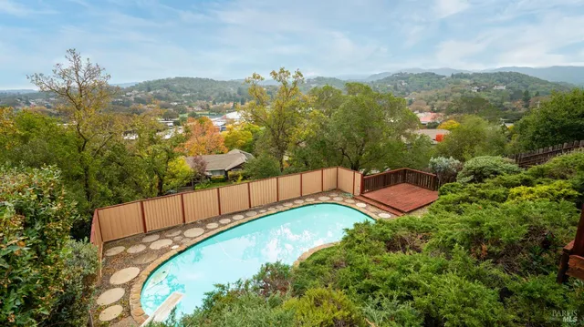 a view of a swimming pool with a yard and mountain view
