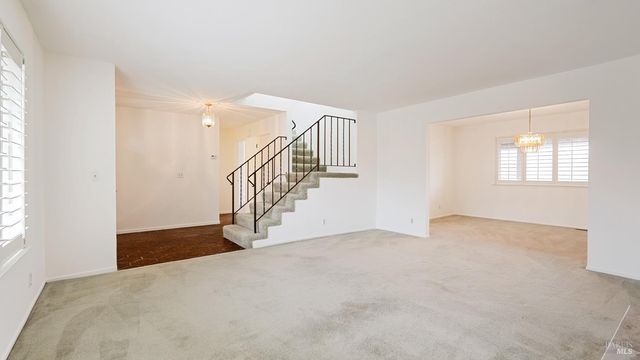 a view of an empty room with stairs