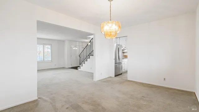 a view of a hallway with a chandelier and chandelier