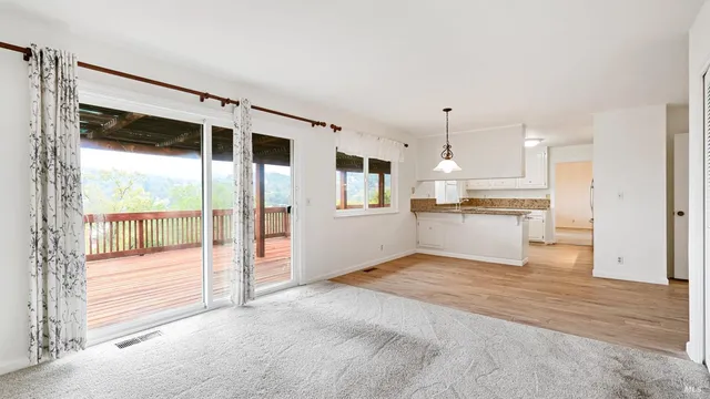 a view of a kitchen with wooden floor and a sink