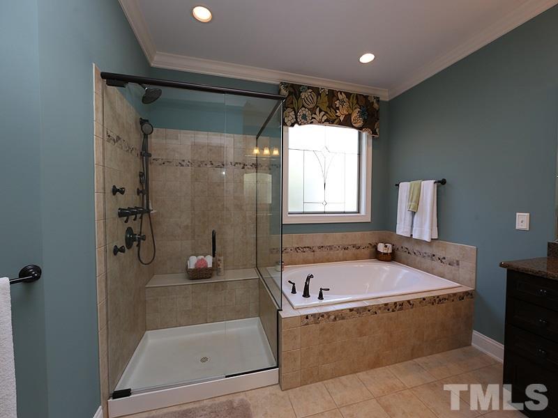 12913 Baybriar Drive Raleigh, NC 27613 - Photo 13 of 25 a bathroom with a tub a sink and a shower