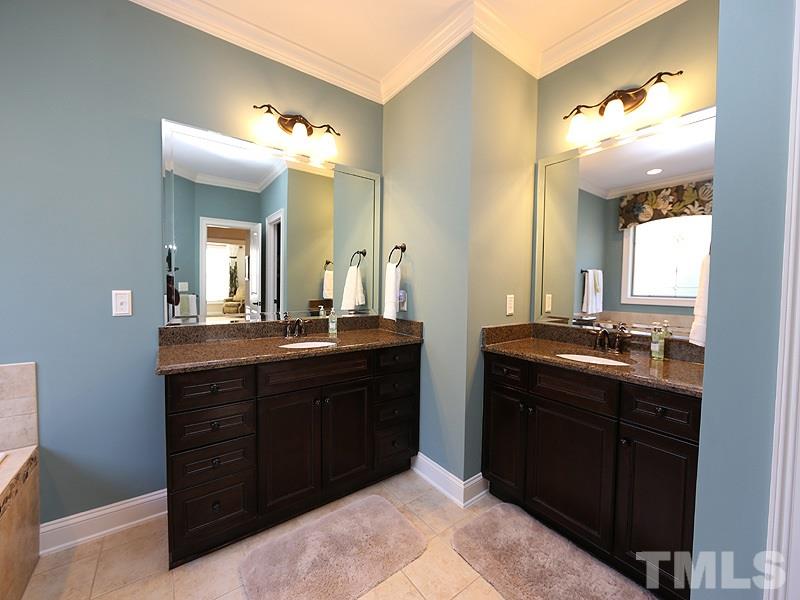 12913 Baybriar Drive Raleigh, NC 27613 - Photo 14 of 25 a bathroom with a double vanity sink and a mirror
